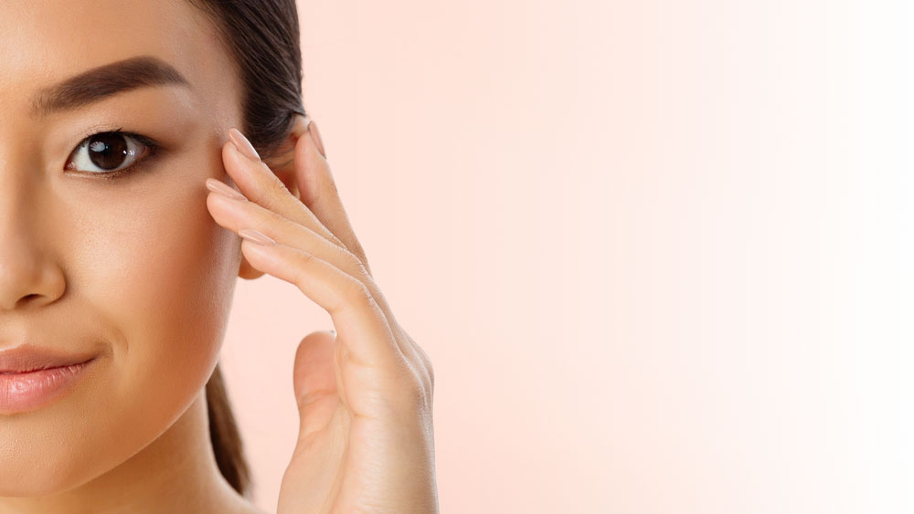 woman touching face skin close up natural light